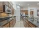 Stylish kitchen featuring granite countertops, modern appliances, and plenty of space for meal preparation at 1416 E Artemis Trl, Queen Creek, AZ 85140