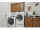 Laundry room with front loading washer and dryer and lots of storage cabinets at 1416 E Artemis Trl, Queen Creek, AZ 85140