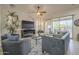 Spacious living room with a large TV, comfortable seating, and sliding doors to the outdoor patio at 1416 E Artemis Trl, Queen Creek, AZ 85140