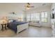 Spacious main bedroom features many windows and a sitting area with a couch at 1416 E Artemis Trl, Queen Creek, AZ 85140