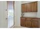 Mud room features custom cabinetry for storage and an exterior door with window at 1416 E Artemis Trl, Queen Creek, AZ 85140