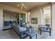 Covered outdoor patio with fireplace and stylish seating arrangements at 1416 E Artemis Trl, Queen Creek, AZ 85140