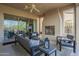 Inviting covered patio featuring a cozy fireplace and comfortable seating, perfect for relaxing at 1416 E Artemis Trl, Queen Creek, AZ 85140