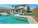 Inviting backyard oasis featuring a sparkling pool, patio furniture, and lush landscaping at 14877 N 145Th Dr, Surprise, AZ 85379