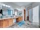 Bathroom with double vanity, large mirror, and access to other rooms at 14877 N 145Th Dr, Surprise, AZ 85379
