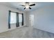 Bright bedroom with ceiling fan and carpet at 14877 N 145Th Dr, Surprise, AZ 85379