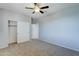 Bedroom with ceiling fan, closet, and carpet at 14877 N 145Th Dr, Surprise, AZ 85379