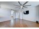 Bedroom with wood-look tile floors, ceiling fan and en-suite bathroom at 14877 N 145Th Dr, Surprise, AZ 85379