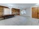 Dining room with wood-paneled accent wall, tile floor, and pool table at 14877 N 145Th Dr, Surprise, AZ 85379