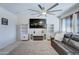 Spacious living room featuring a large TV, fireplace, and comfortable seating at 14877 N 145Th Dr, Surprise, AZ 85379