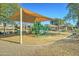 Community playground with shaded play structures and benches at 14877 N 145Th Dr, Surprise, AZ 85379