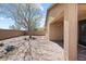 Landscaped backyard with paved patio and mature tree at 1719 W Owens Way, Anthem, AZ 85086