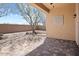 Backyard patio with decorative wall art and mature tree at 1719 W Owens Way, Anthem, AZ 85086