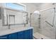 Bathroom with blue vanity, dual sinks, and glass shower at 1719 W Owens Way, Anthem, AZ 85086