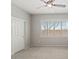 Bedroom with large window, closet and ceiling fan at 1719 W Owens Way, Anthem, AZ 85086
