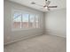 Bright bedroom with ceiling fan and large window at 1719 W Owens Way, Anthem, AZ 85086