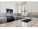 Modern kitchen with granite countertops and gray cabinets at 1719 W Owens Way, Anthem, AZ 85086
