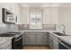 Modern kitchen with granite countertops and gray cabinets at 1719 W Owens Way, Anthem, AZ 85086