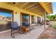 Covered patio with rocking chairs and wicker side table at 178 Leisure World --, Mesa, AZ 85206