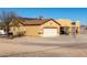 House exterior with a two-car garage and solar panels at 18706 W Arlington Rd, Buckeye, AZ 85326