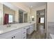 Elegant bathroom with double vanity, quartz countertops, and a walk-in shower at 20823 W Rainbow Trl, Buckeye, AZ 85326