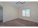 Simple bedroom with neutral walls, carpet, and ceiling fan at 20823 W Rainbow Trl, Buckeye, AZ 85326