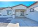 Modern home's front entrance with a covered porch and white door at 20823 W Rainbow Trl, Buckeye, AZ 85326