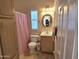 Clean bathroom with a single vanity and tub shower combo at 2101 S Meridian Rd # 39, Apache Junction, AZ 85120