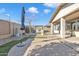 Backyard patio with grassy area and umbrella at 22455 E Camina Buena Vis, Queen Creek, AZ 85142