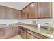 Well-equipped kitchen featuring ample cabinetry and granite countertops at 22455 E Camina Buena Vis, Queen Creek, AZ 85142