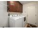 Bright laundry room, washer, dryer, and ample cabinets at 226 S 122Nd Ln, Avondale, AZ 85323