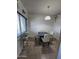 Cozy dining area featuring tile floors and a charming four-chair dining set, perfect for intimate meals at 2315 W Union Hills Dr # 115, Phoenix, AZ 85027