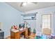 Office space with natural light, storage shelves, and a functional desk setup, ideal for a home office at 2315 W Union Hills Dr # 115, Phoenix, AZ 85027