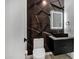 Stylish powder room, black sink vanity, and geometric wallcovering at 2330 N 28Th Pl, Phoenix, AZ 85008