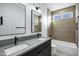 Modern bathroom with double vanity, gray countertops, and a large shower at 2330 N 28Th Pl, Phoenix, AZ 85008