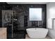Elegant bathroom with a free-standing tub and black marble tile at 2330 N 28Th Pl, Phoenix, AZ 85008