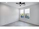 Well-lit bedroom with ceiling fan and grey tile flooring at 2330 N 28Th Pl, Phoenix, AZ 85008