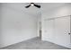 Bright bedroom with ceiling fan and sliding closet doors at 2330 N 28Th Pl, Phoenix, AZ 85008