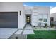 Contemporary home with gray garage door and walkway, plus drought-tolerant landscaping at 2330 N 28Th Pl, Phoenix, AZ 85008