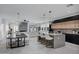 Modern kitchen with large island, wood and black cabinetry, and geometric lighting at 2330 N 28Th Pl, Phoenix, AZ 85008