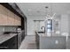Contemporary kitchen with large island and black and wood cabinets at 2330 N 28Th Pl, Phoenix, AZ 85008