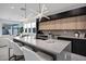 Modern kitchen with large island and view into the living room at 2330 N 28Th Pl, Phoenix, AZ 85008