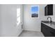 Laundry room with black cabinets and a window at 2330 N 28Th Pl, Phoenix, AZ 85008