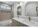 Modern bathroom with double sinks and arched mirrors at 2336 N 28Th Pl, Phoenix, AZ 85008