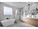 Spa-like bathroom featuring a freestanding tub, marble, and double vanity at 2336 N 28Th Pl, Phoenix, AZ 85008