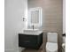 Modern bathroom with floating vanity, illuminated mirror, and textured walls at 2336 N 28Th Pl, Phoenix, AZ 85008