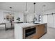 Contemporary kitchen island with built-in microwave and wooden cabinetry at 2336 N 28Th Pl, Phoenix, AZ 85008