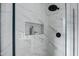 Modern glass shower with marble tile and built-in shelf at 2336 N 28Th Pl, Phoenix, AZ 85008