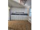 Kitchen with white cabinets and laminate flooring at 2650 W Union Hills Dr # 33, Phoenix, AZ 85027