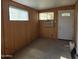 Living room with wood paneling, window, and AC unit at 2650 W Union Hills Dr # 33, Phoenix, AZ 85027